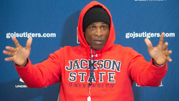 Deion Sanders speaks at a press conference.